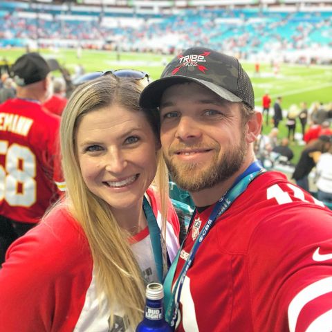 Lexi Murphy and Max Thieriot are on the football ground.